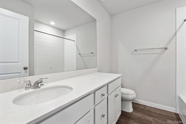 bathroom with hardwood / wood-style flooring, vanity, and toilet