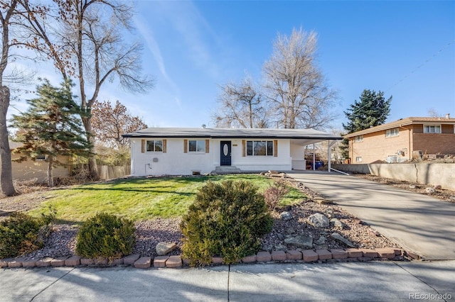 ranch-style home with a front lawn and a carport