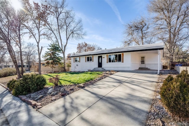 ranch-style house featuring a front yard and a carport