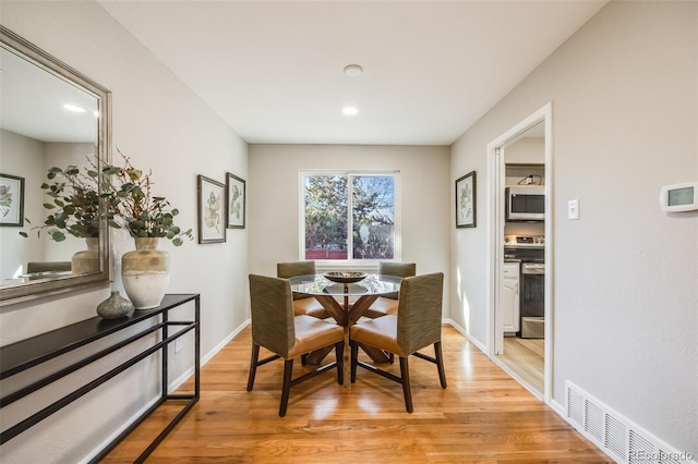 dining room with light hardwood / wood-style floors