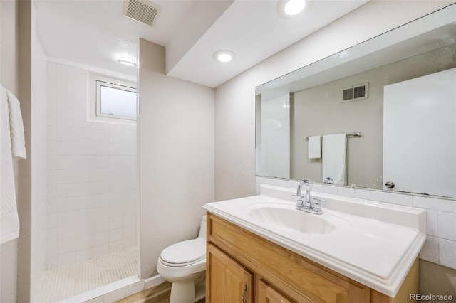 bathroom featuring a shower, wood-type flooring, vanity, and toilet