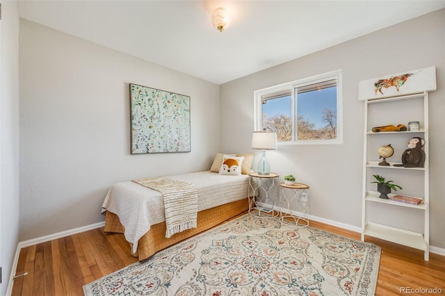 bedroom with hardwood / wood-style flooring