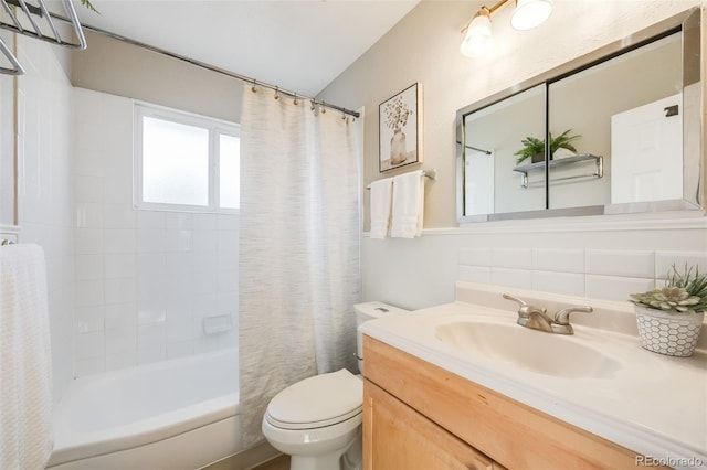 full bathroom with vanity, shower / bath combination with curtain, and toilet