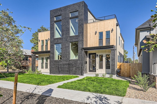 contemporary house featuring a front lawn