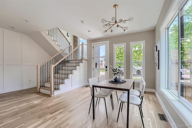 dining room with a chandelier and light hardwood / wood-style flooring