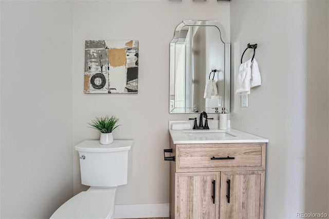 bathroom with toilet and vanity