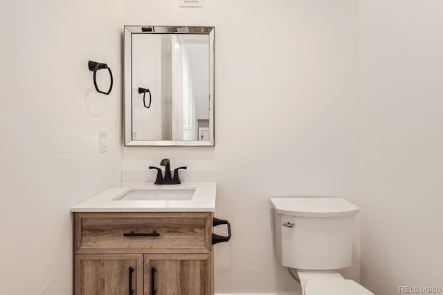 bathroom with toilet and vanity