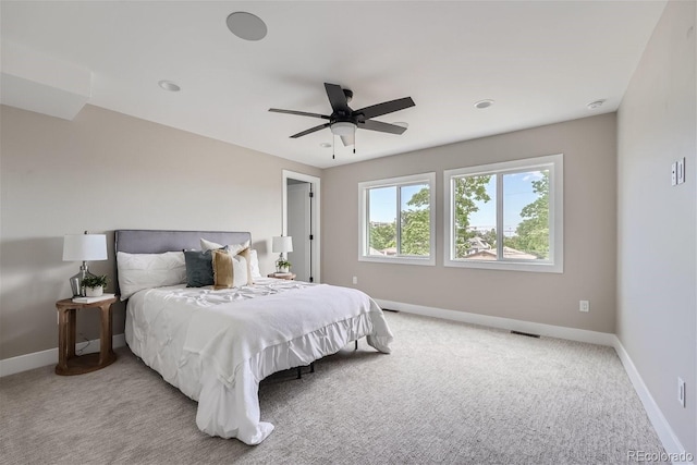 bedroom with ceiling fan and light carpet