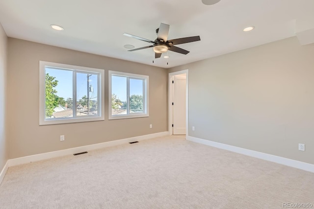 unfurnished room with ceiling fan and light colored carpet