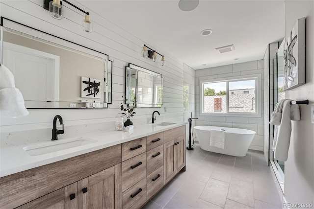 bathroom featuring vanity, shower with separate bathtub, and tile patterned floors