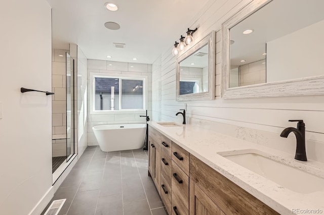 bathroom with vanity, tile patterned floors, and shower with separate bathtub