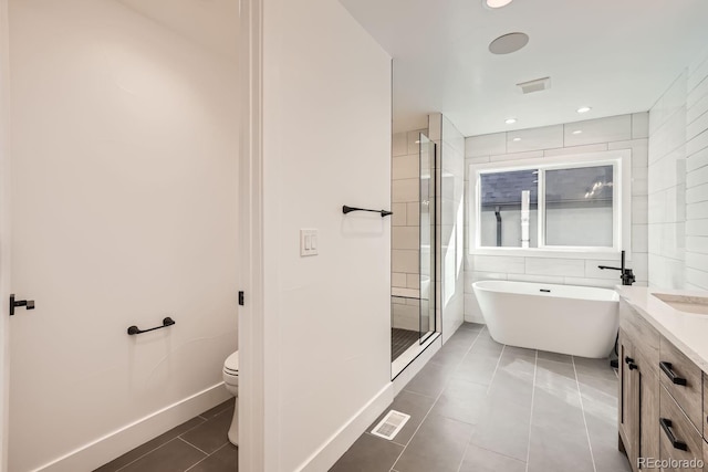 full bathroom with toilet, vanity, plus walk in shower, and tile patterned flooring