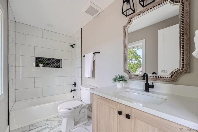 full bathroom featuring vanity, toilet, and tiled shower / bath combo