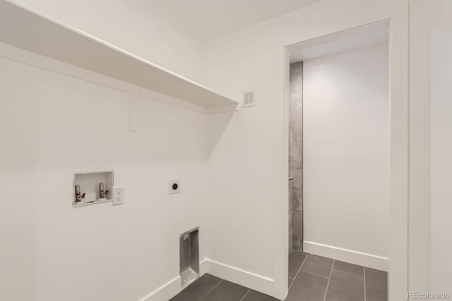 washroom featuring washer hookup, dark tile patterned floors, and hookup for an electric dryer