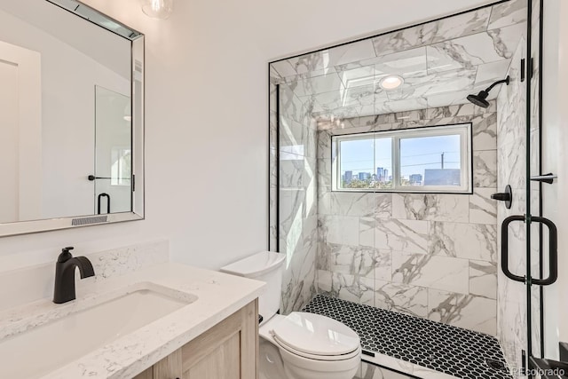 bathroom with toilet, an enclosed shower, and vanity