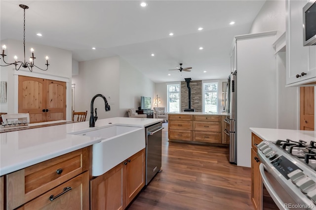 19745 Hopi Pines Grv, Peyton, CO 80831 - kitchen featuring stainless steel appliances, dark wood finished floors, recessed lighting, open floor plan, and a chandelier