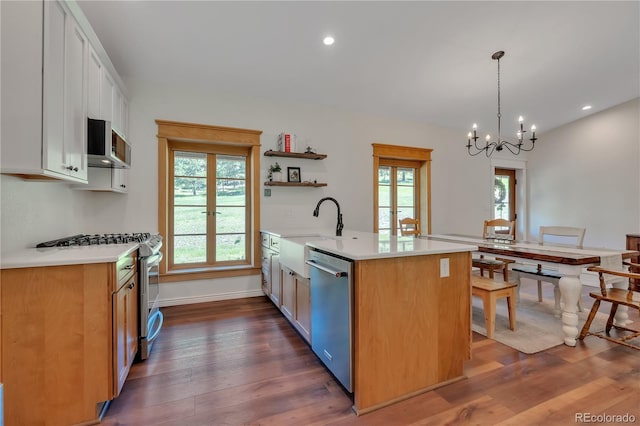 19745 Hopi Pines Grv, Peyton, CO 80831 - kitchen with stainless steel appliances, light countertops, a chandelier, open shelves, and recessed lighting