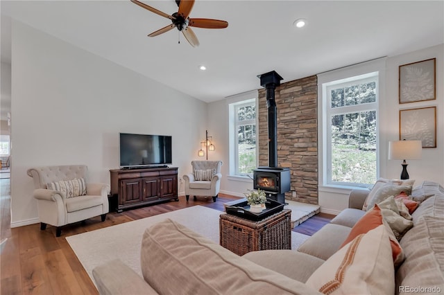 19745 Hopi Pines Grv, Peyton, CO 80831 - living area featuring a wood stove, hardwood / wood-style flooring, ceiling fan, recessed lighting, and lofted ceiling