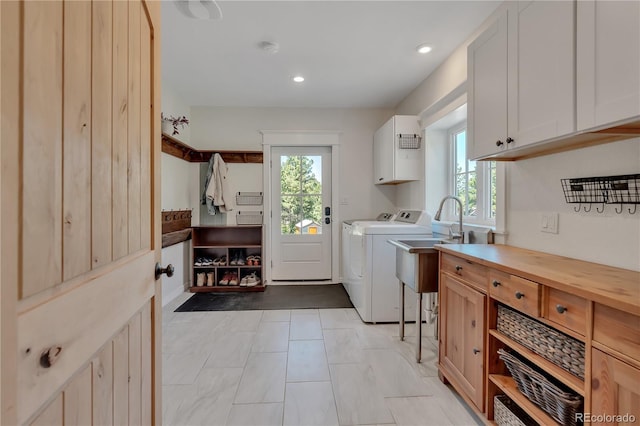19745 Hopi Pines Grv, Peyton, CO 80831 - laundry area with cabinet space, washing machine and dryer, plenty of natural light, and recessed lighting