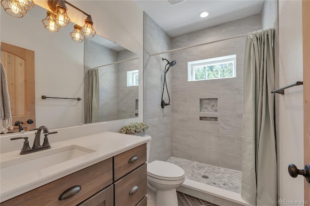 19745 Hopi Pines Grv, Peyton, CO 80831 - bathroom with vanity, tiled shower, and recessed lighting