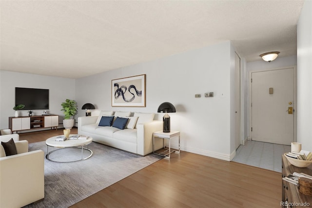 living room featuring hardwood / wood-style floors and a textured ceiling