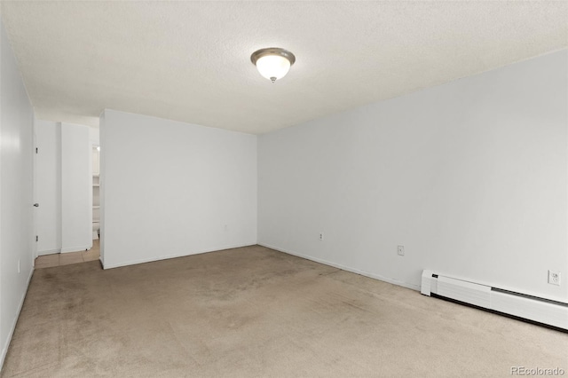 carpeted spare room featuring baseboard heating and a textured ceiling