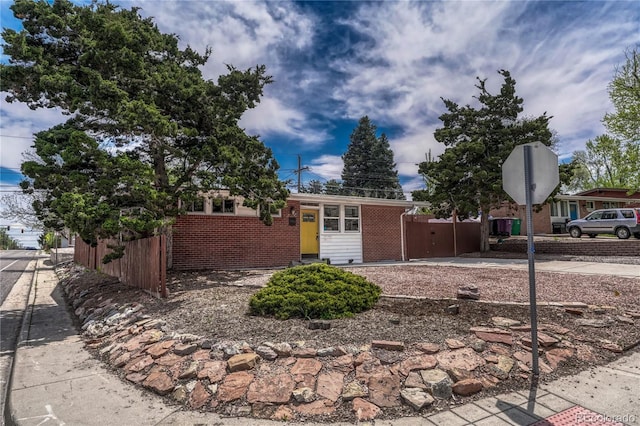 1906 S Vrain St, Denver, CO 80219 - view of front of home with brick siding and fence