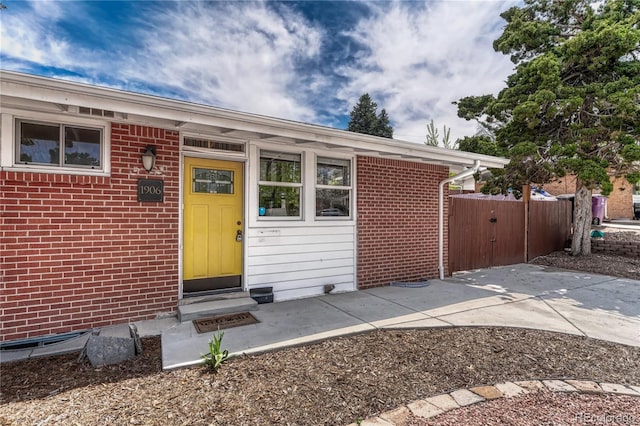 1906 S Vrain St, Denver, CO 80219 - property entrance featuring a gate, brick siding, and fence