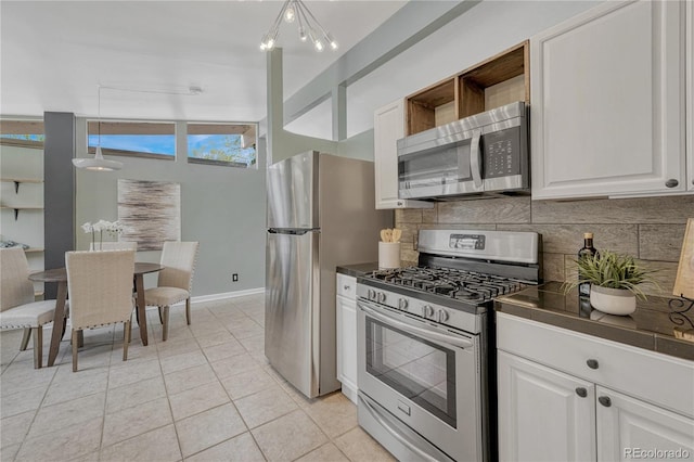 1906 S Vrain St, Denver, CO 80219 - kitchen featuring stainless steel appliances, dark countertops, backsplash, open shelves, and light tile patterned flooring