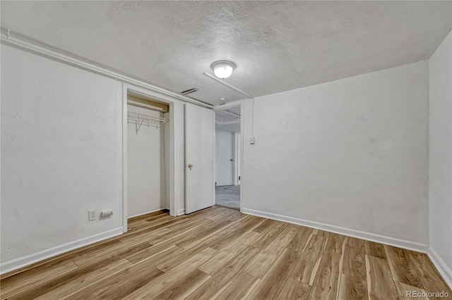 1906 S Vrain St, Denver, CO 80219 - unfurnished bedroom featuring light wood-style floors, a textured ceiling, a closet, and baseboards