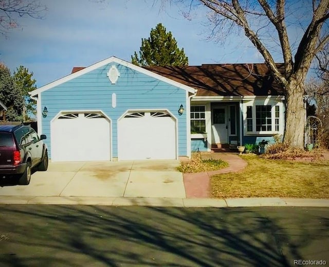 single story home with a garage and a front yard