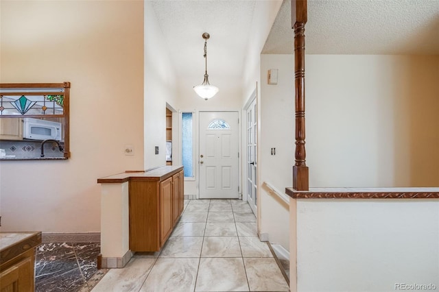 entryway with a textured ceiling