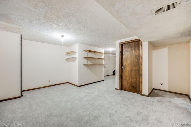 interior space with light carpet and a textured ceiling