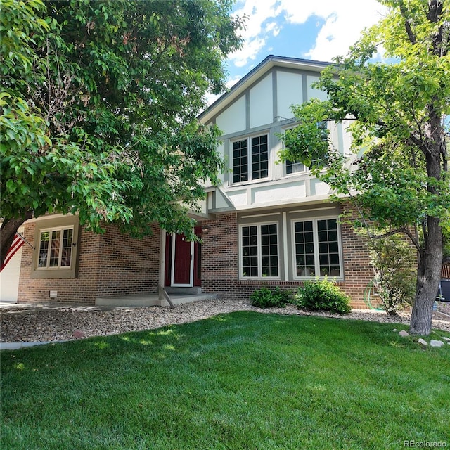 16639 E Berry Ln, Centennial, CO 80015 - tudor house featuring brick siding, a front lawn, and stucco siding