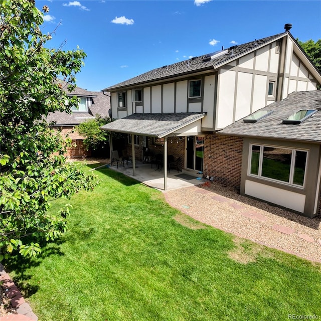 16639 E Berry Ln, Centennial, CO 80015 - rear view of property featuring a patio, a shingled roof, brick siding, and stucco siding