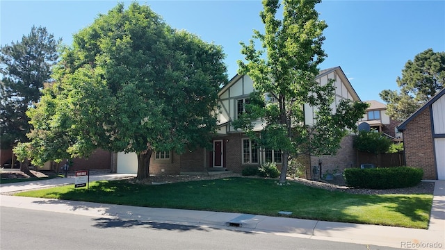 16639 E Berry Ln, Centennial, CO 80015 - tudor home featuring brick siding and a front lawn