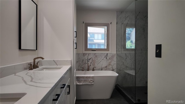16639 E Berry Ln, Centennial, CO 80015 - full bathroom with double vanity, tile walls, a freestanding tub, tile patterned flooring, and a marble finish shower