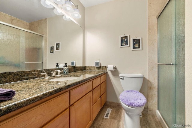 1851 E 138th Ave, Brighton, CO 80602 - full bathroom featuring vanity, a stall shower, toilet, and baseboards