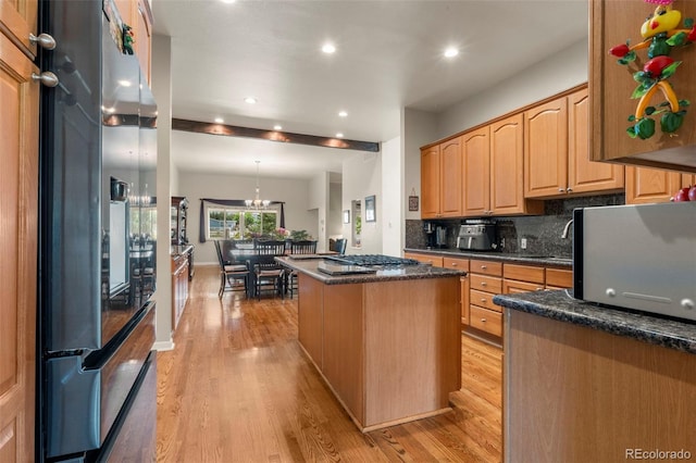 1851 E 138th Ave, Brighton, CO 80602 - kitchen with stainless steel appliances, a kitchen island, light wood finished floors, recessed lighting, and backsplash