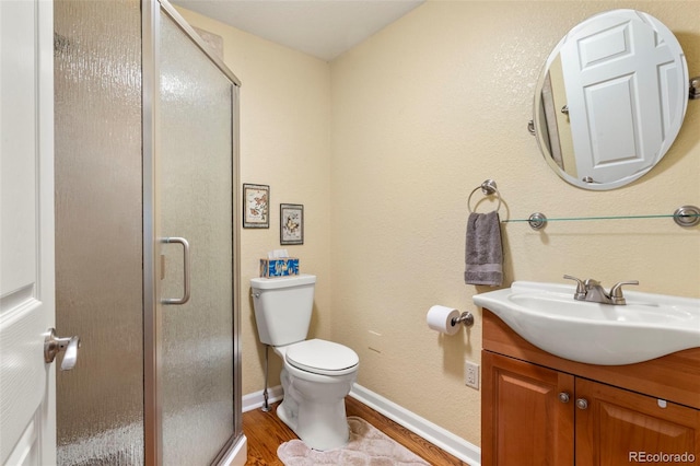 1851 E 138th Ave, Brighton, CO 80602 - full bath with vanity, wood finished floors, a shower stall, toilet, and baseboards