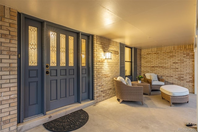 property entrance with brick siding and covered porch