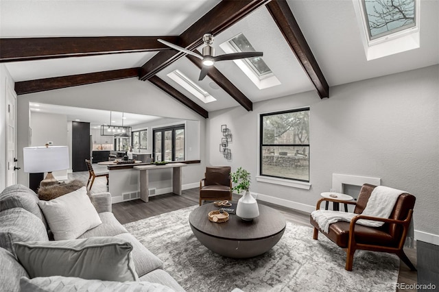 11861 E Yale Ct, Aurora, CO 80014 - living room with a skylight, wood finished floors, a chandelier, and ceiling fan