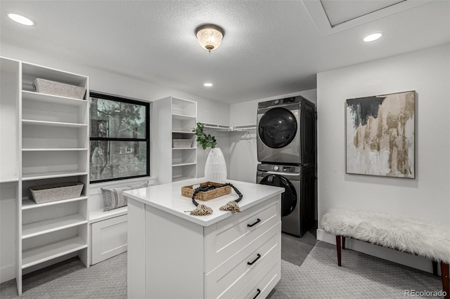 11861 E Yale Ct, Aurora, CO 80014 - walk in closet with stacked washer and clothes dryer and light colored carpet