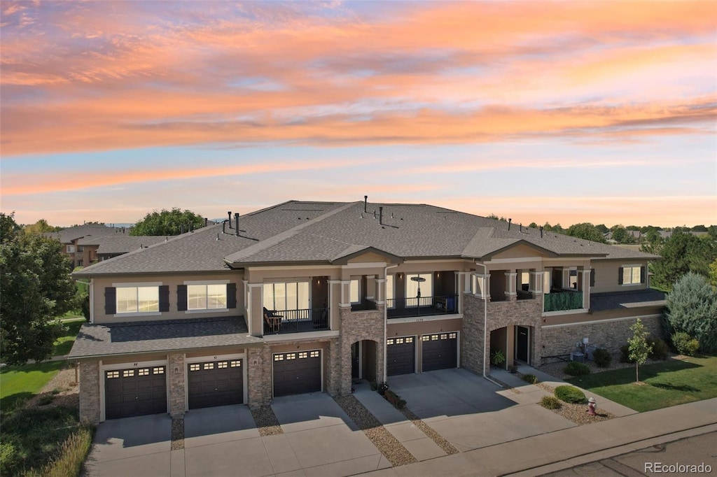 prairie-style house featuring a balcony and a garage