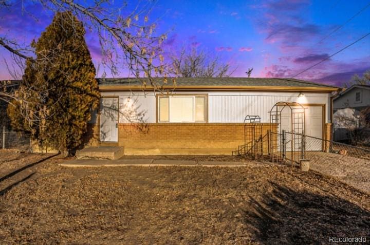 back house at dusk with a garage