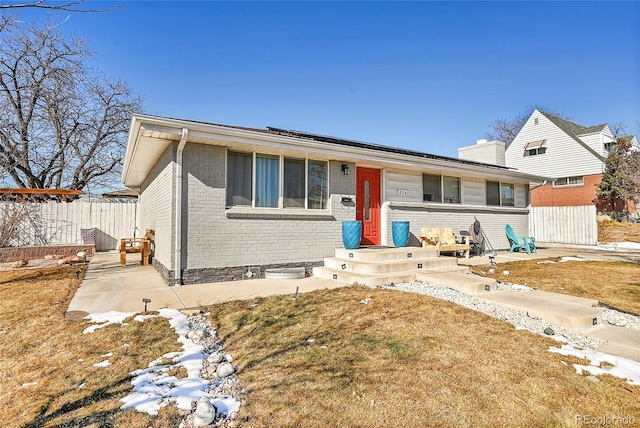 view of front of house with a patio area and a front lawn