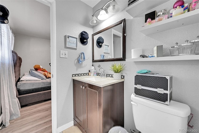 bathroom with vanity, hardwood / wood-style floors, and toilet