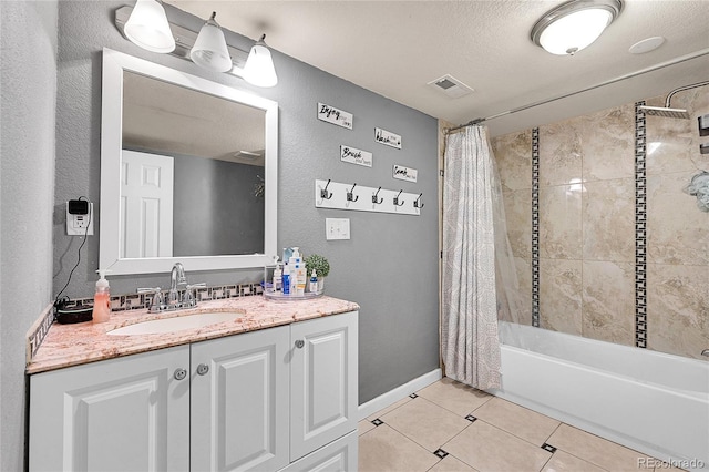 bathroom featuring shower / bath combo, tile patterned floors, a textured ceiling, and vanity