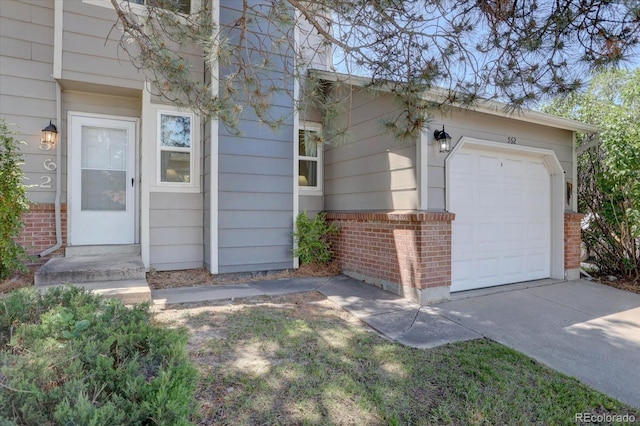 562 W Crestline Cir Unit 7D, Littleton, CO 80120 - doorway to property with brick siding, driveway, and an attached garage