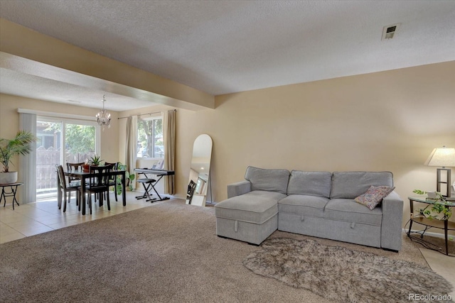 562 W Crestline Cir Unit 7D, Littleton, CO 80120 - living area with a chandelier, carpet floors, a textured ceiling, and arched walkways